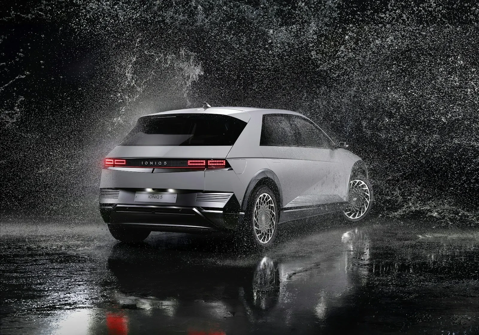 a white volkswagen suv driving through a rain storm