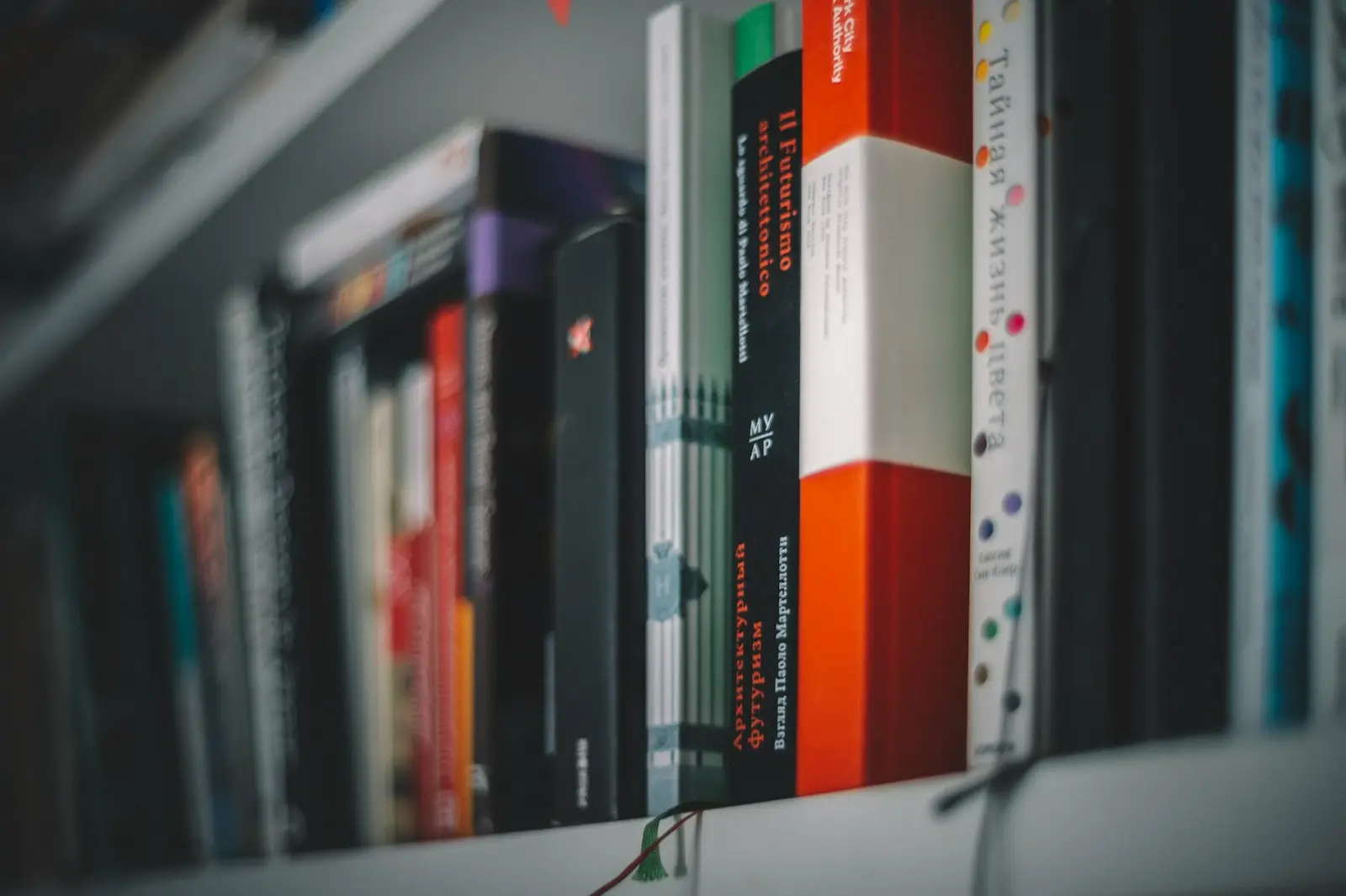 books on white wooden shelf