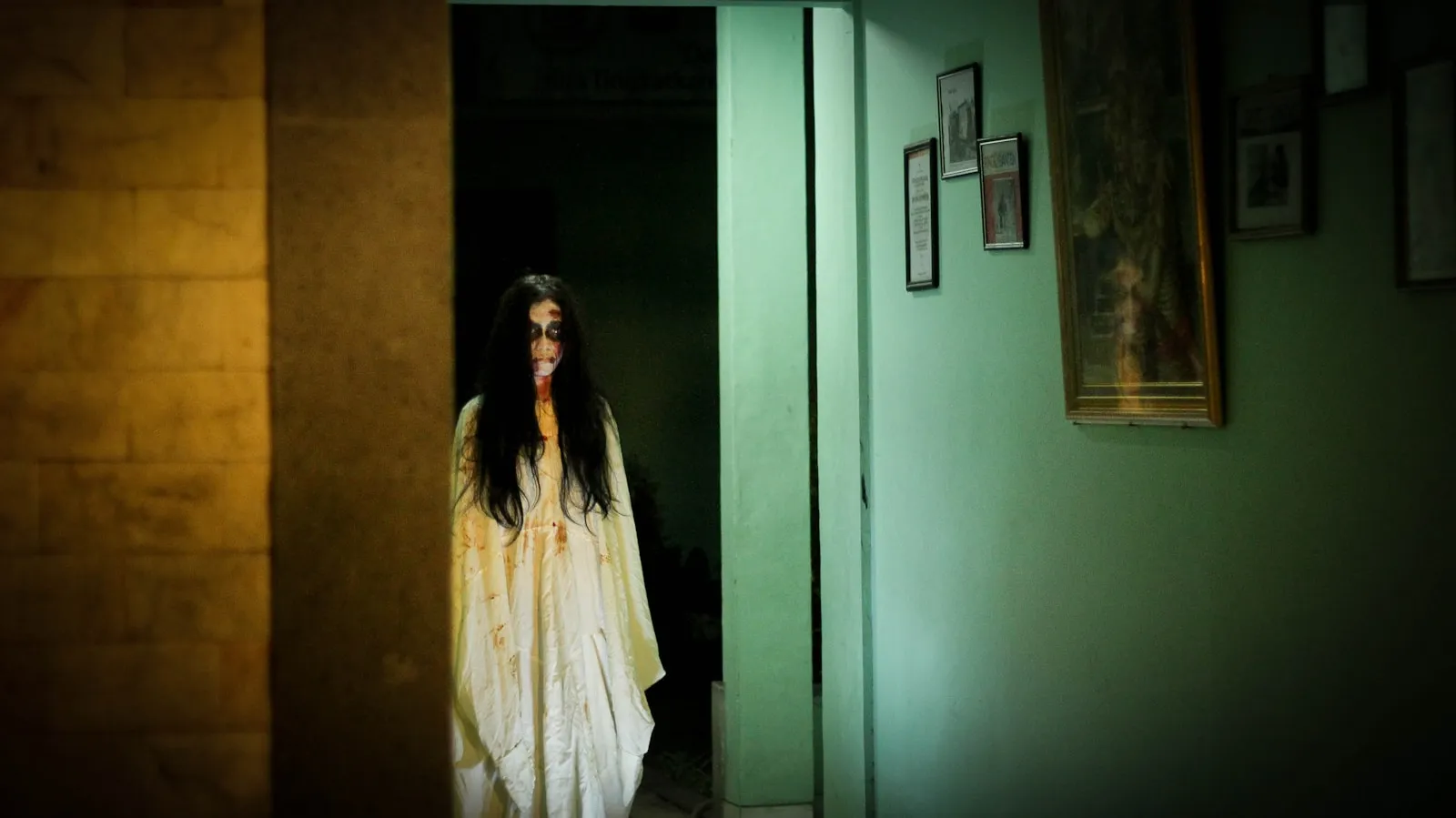 a woman dressed as a ghost standing in a doorway