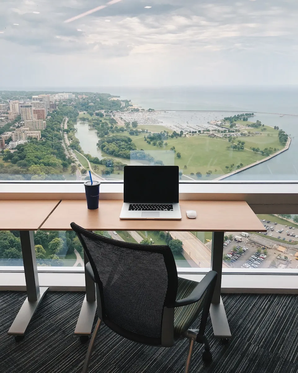 a laptop computer sitting on top of a wooden desk