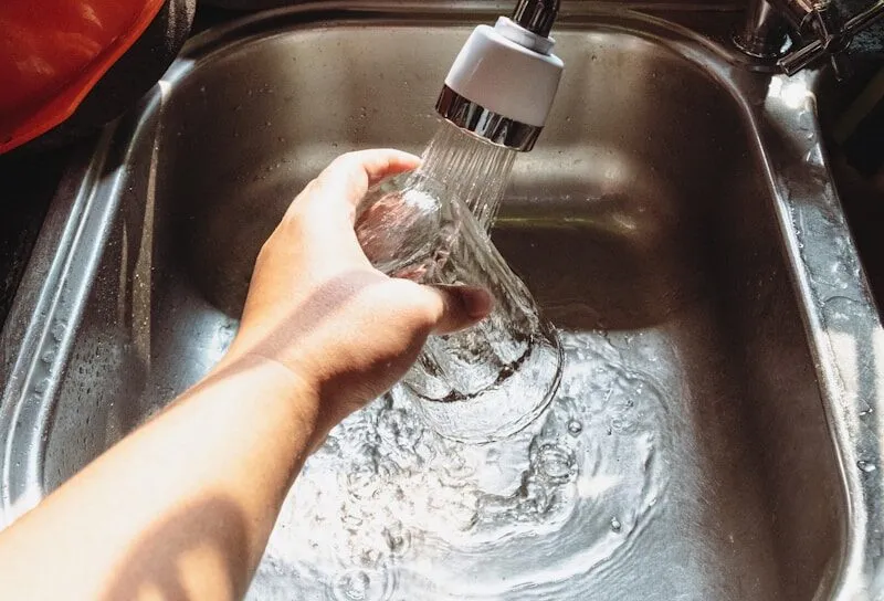 a hand holding a water bottle