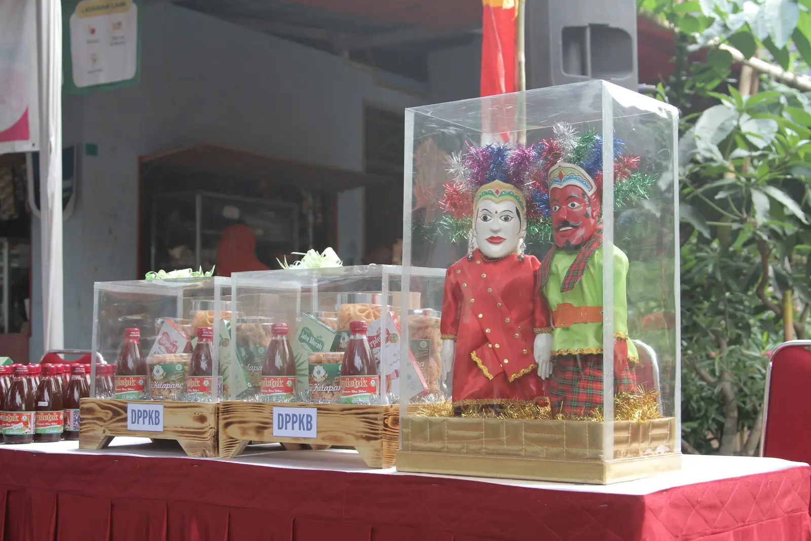 a table topped with a display case filled with bottles of liquid