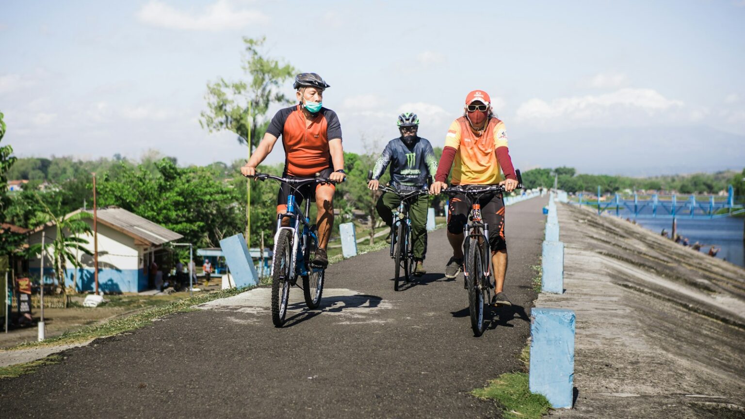 group of people riding bicycle on road during daytime
